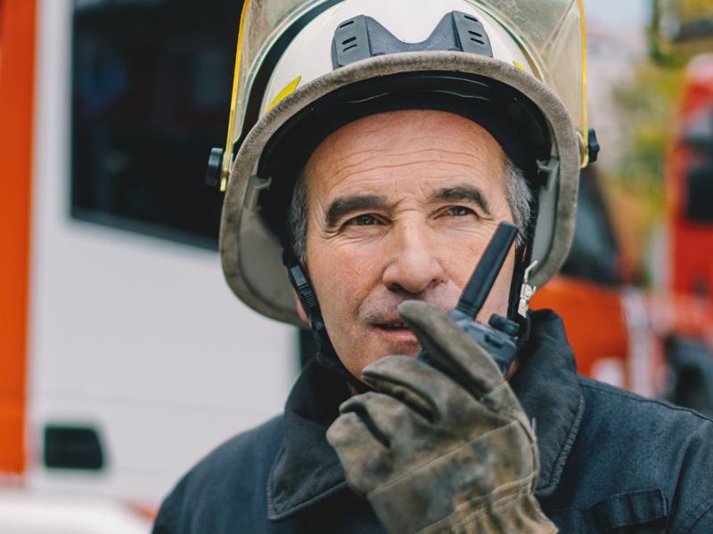 Två flygplats arbetare som talar i en komradio samtidigt som de pratar med varandra