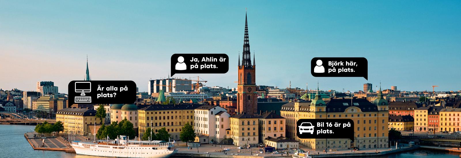 Stad där kollegor pratar med PTT i GroupTalk till varandra mellan olika byggnader